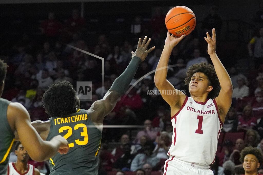 Sue Ogrocki Oklahoma forward Jalen Hill (1) shoots over Baylor forward Jonathan Tchamwa Tchatchoua (23) in the second half of an NCAA college basketball game Saturday, Jan. 22, 2022, in Norman, Okla. (AP Photo/Sue Ogrocki)