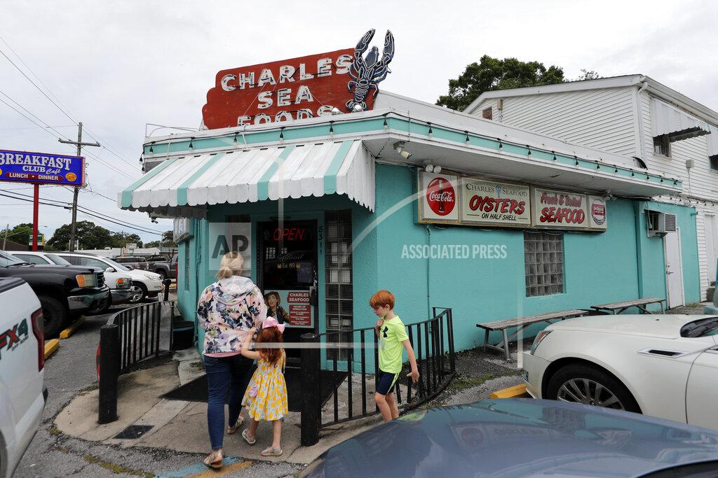 Gerald Herbert Customers enter Charles Seafood Restaurant for indoor sit-down service, for the first time since the state shutdown, in Harahan, La., Friday, May 15, 2020. Once a hot spot for coronavirus infections, Louisiana is officially easing up Friday on economically devastating business closures and public gathering restrictions that Gov. John Bel Edwards credits with slowing the spread of the virus. (AP Photo/Gerald Herbert)