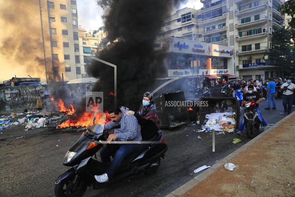 Hussein Malla Saad Hariri's supporters block streets in Beirut, Lebanon, Thursday, July 15, 2021. Prime Minister-designate Saad Hariri said he is stepping down, nine months after he was named to the post by the parliament - the announcement is likely to plunge the country further into more chaos and uncertainty. (AP Photo/Hussein Malla)