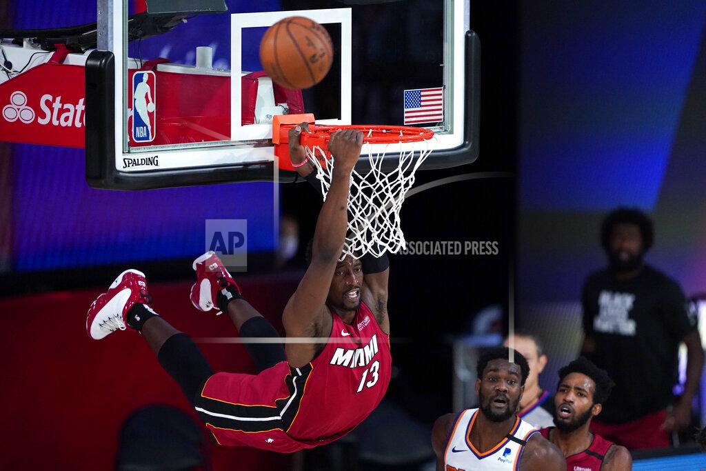 Ashley Landis Miami Heat's Bam Adebayo (13) dunks over Phoenix Suns' Deandre Ayton during the second half of an NBA basketball game, Saturday, Aug. 8, 2020 in Lake Buena Vista, Fla. (AP Photo/Ashley Landis, Pool)