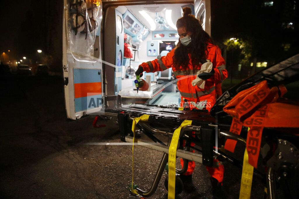 Luca Bruno Medical volunteer Beatrice Ammattatiello, sanitizes the ambulance after carrying a suspected Covid patient to the Bassini hospital during their shift with the emergency White Cross, in Cinisello Balsamo, near Monza, Italy, Thursday, Nov. 19, 2020. The city of Monza north of Milan is best known for its Formula 1 racetrack. In 2020, it has been the ambulance service that has been doing most of the racing. Over three days that an Associated Press photographer traveled on night calls with an ambulance service, the Monza-Brianza province of some 875,000 bordering Milan added 2,500 new cases, part of Italy’s new epicenter in the Lombardy region. (AP Photo/Luca Bruno)