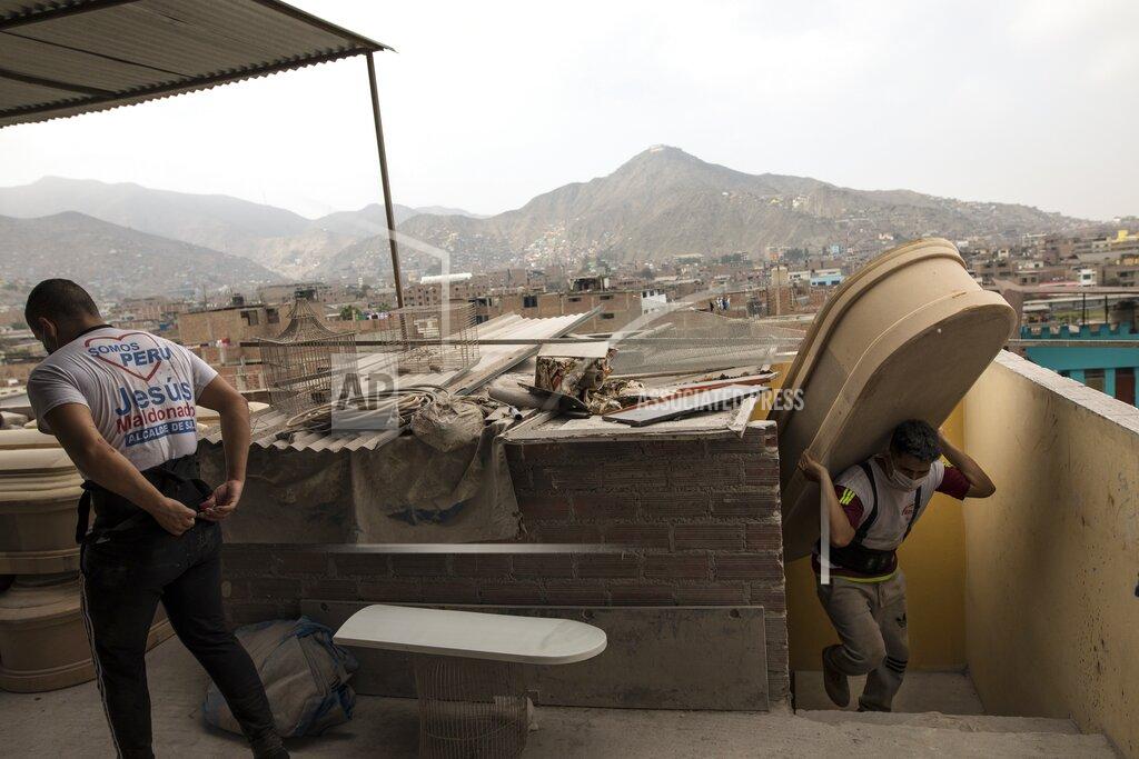 Rodrigo Abd Wilfredo Cabrera carries a new coffin to a store inside a coffin factory in the Juan de Lurigancho neighborhood of Lima, Peru, Thursday, June 4, 2020. As the number of COVID-19 deaths in Peru rapidly mounts, the South American country is becoming one of the epicenters for the virus outbreak in Latin America. (AP Photo/Rodrigo Abd)
