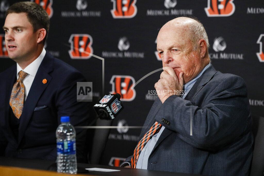John Minchillo Cincinnati Bengals owner Mike Brown, right, listens as the new head coach Zac Taylor, left, answers reporter's questions during a news conference, Tuesday, Feb. 5, 2019, in Cincinnati. After 16 years without a playoff win under Marvin Lewis, the Bengals decided to try something different. But they had to wait more than a month before hiring Zac Taylor as their next coach in hopes of ending a long streak of futility. (AP Photo/John Minchillo)