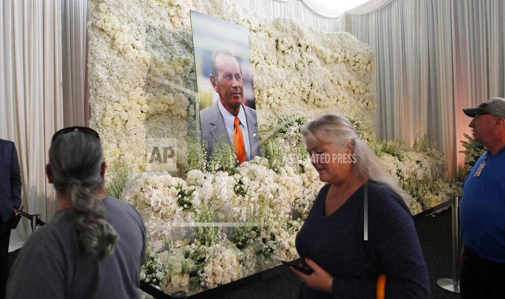 David Zalubowski Fans file past a wall of flowers with a portrait of Denver Broncos owner Pat Bowlen placed in the center during a memorial Tuesday, June 18, 2019, at Mile High Stadium, the NFL football team's home in Denver. Bowlen, who has owned the franchise for more than three decades, died last Thursday. (AP Photo/David Zalubowski)