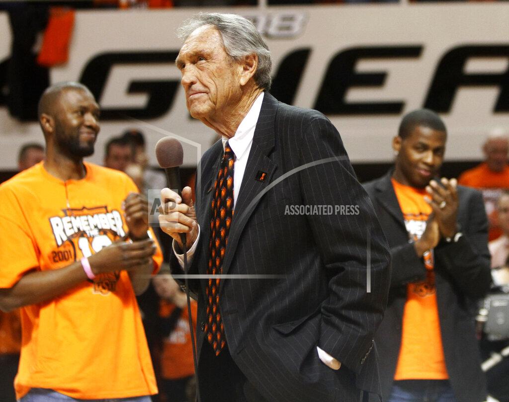 Sue Ogrocki FILE - In this Wednesday, Jan. 26, 2011, file photo, former Oklahoma State coach Eddie Sutton, center, talks to fans during a ceremony honoring the 10th anniversary of the death of 10 members of the Oklahoma State basketball program in a plane crash, at halftime of an NCAA college basketball game between Oklahoma State and Texas in Stillwater, Okla. Sutton, the Hall of Fame basketball coach who led three teams to the Final Four and was the first coach to take four schools to the NCAA Tournament, died Saturday, May 23, 2020. He was 84. (AP Photo/Sue Ogrocki, File)
