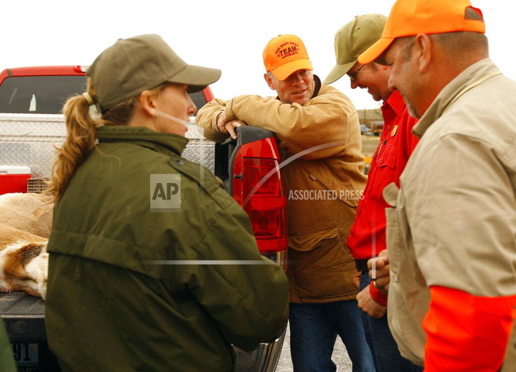 Dan Cepeda FILE - In this Sept. 17, 2011, file photo former Gov. Matt Mead, center, talks with regional wildlife manager Jason Hunter at a check station just outside of Lander, Wyo. Mead was participating in the annual One Shot Antelope Hunt event. The coronavirus has canceled the charity antelope hunt that has drawn teams of famous, powerful men to central Wyoming for over 75 years and now faces growing criticism that ceremonies tied to the event crudely and inaccurately depict Native American culture. (Dan Cepeda/The Casper Star-Tribune via AP)