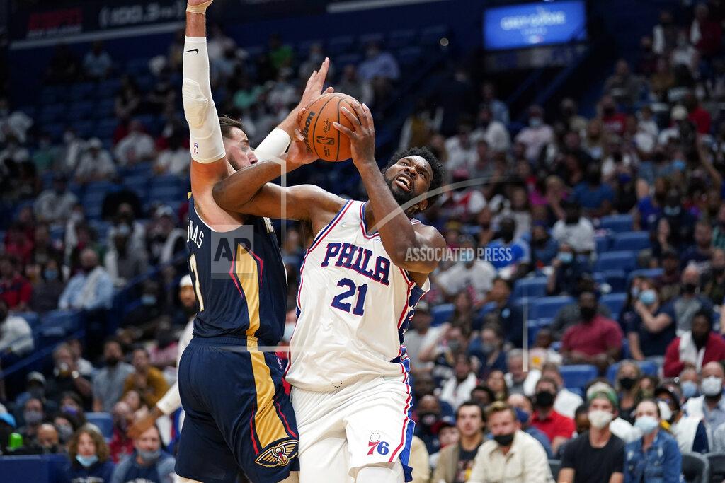 Gerald Herbert Philadelphia 76ers center Joel Embiid (21) goes to the basket against New Orleans Pelicans center Jonas Valanciunas in the first half of an NBA basketball game in New Orleans, Wednesday, Oct. 20, 2021. (AP Photo/Gerald Herbert)
