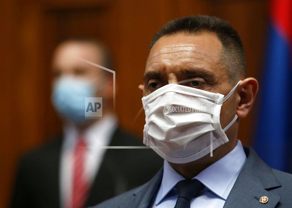 In this Tuesday, April 28, 2020. file photo, Serbia Defense Minister Aleksandar Vulin wearing a mask to protect against coronavirus attends the session in Belgrade, Serbia. The Defense Ministry says Serbia's Defense Minister Aleksandar Vulin has tested positive with the coronavirus. (AP Photo/Darko Vojinovic, File)
