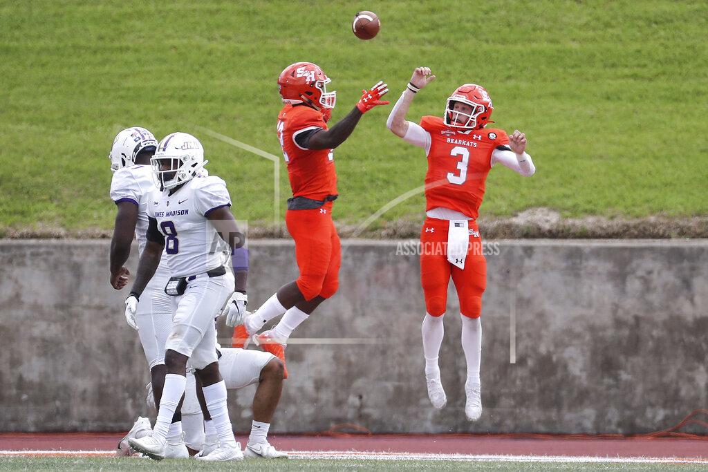 Brett Coomer Sam Houston State quarterback Eric Schmid (3) and wide receiver Jequez Ezzard (12) celebrate Schid's touchdown against James Madison during the third quarter of a semifinal game in the NCAA college football FCS playoffs, Saturday, May 8, 2021, in Huntsville, Texas. Sam Houston came from behind to edge James Madison 38-35, for a berth in the FCS national championship game. (Brett Coomer/Houston Chronicle via AP)
