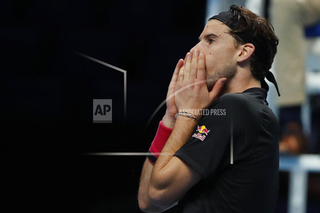 Frank Augstein Dominic Thiem of Austria celebrates after winning his semifinal match against Novak Djokovic of Serbia at the ATP World Finals tennis tournament at the O2 arena in London, Saturday, Nov. 21, 2020. (AP Photo/Frank Augstein)