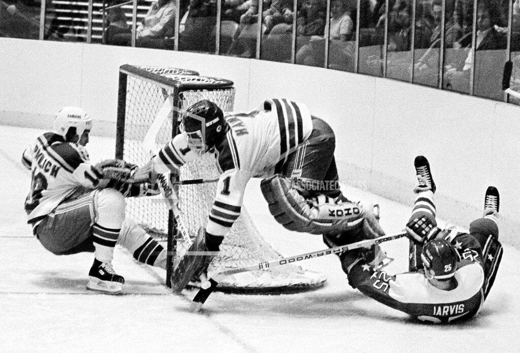 Ron Frehm FILE - In this Dec. 7, 1983, file photo, Washington Capitals' Doug Jarvis (25), right, scores a goal against New York Rangers goalie Glen Hanlon during the first period of an NHL hockey game at Madison Square Garden in New York. The puck slides into the goal off the skates of Rangers' Mark Pavelich, left. Pavelich has died at a treatment center for mental illness. Officials in Anoka County, Minnesota, confirmed Friday, March 5, 2021, that Pavelich, 63, died at Eagle's Healing Nest in Sauk Centre, Minn., Thursday morning. The cause and manner of death are still pending. (AP Photo/Ron Frehm, File)