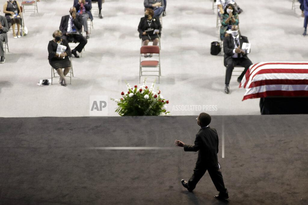 Brynn Anderson Jackson Lewis Brewster, great nephew, of the late Rep. John Lewis, D-Ga., walks off stage during a service at Troy University on Saturday, July 25, 2020, in Troy, Ala. Lewis, who carried the struggle against racial discrimination from Southern battlegrounds of the 1960s to the halls of Congress, died Friday, July 17, 2020. (AP Photo/Brynn Anderson)