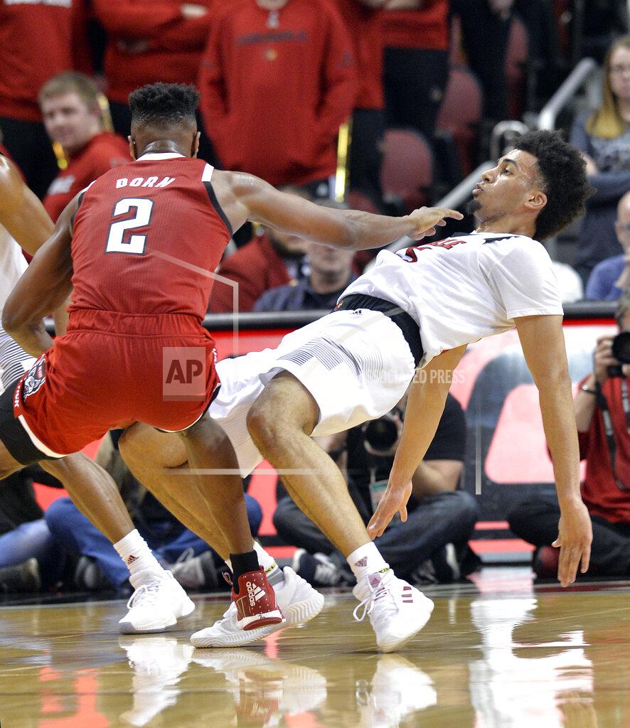 Timothy D. Easley Louisville forward Jordan Nwora (33) takes a charge from North Carolina State guard Torin Dorn (2) during the second half of an NCAA college basketball game in Louisville, Ky., Thursday, Jan. 24, 2019. Louisville won 84-77. (AP Photo/Timothy D. Easley)