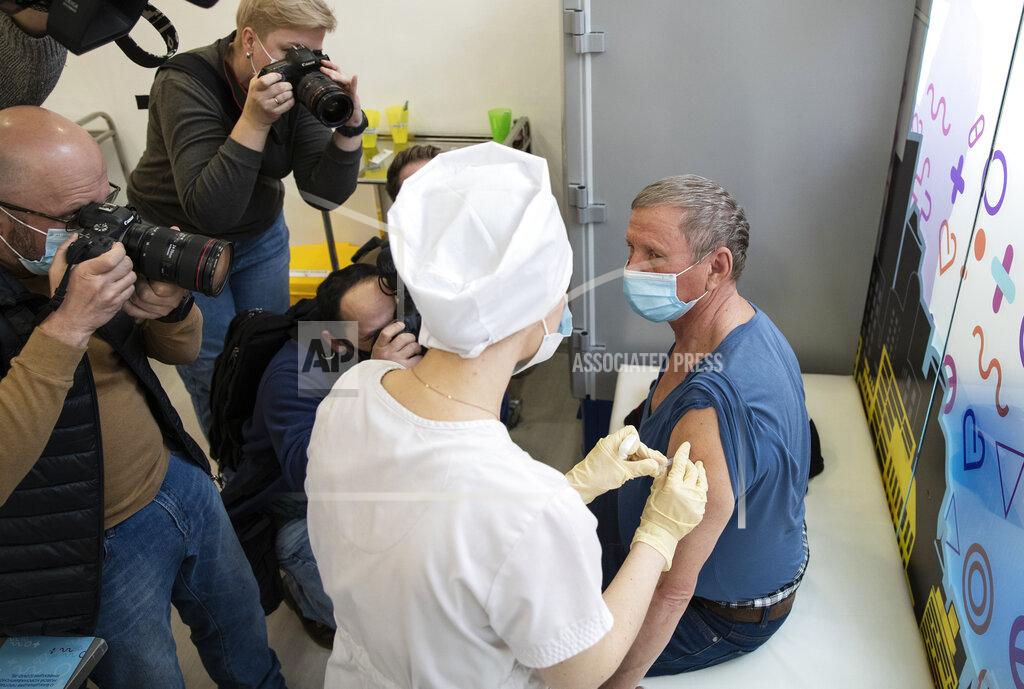 Pavel Golovkin News photographers take pictures as a medical worker administers a shot of Russia's Sputnik V coronavirus vaccine in Moscow, Russia, Wednesday, April 7, 2021. Germany’s health minister Jens Spahn said Thursday April 8, 2021, the European Union doesn’t plan to order Russia’s Sputnik V coronavirus vaccine but will hold separate talks with Russia. (AP Photo/Pavel Golovkin)
