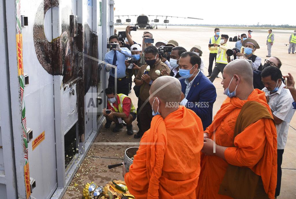 Neth Pheaktra, center, Spokesmen of Environment Ministry, presides over the blessing of a container holding Kaavan the elephant during its arrival from Pakistan at the Siem Reap International Airport, Cambodia, Monday, Nov. 30, 2020. Kaavan, dubbed the "world's loneliest elephant" after languishing alone for years in a Pakistani zoo, has arrived in Cambodia where a sanctuary with the much-needed company of other elephants awaits him. (Pool Photo via AP)