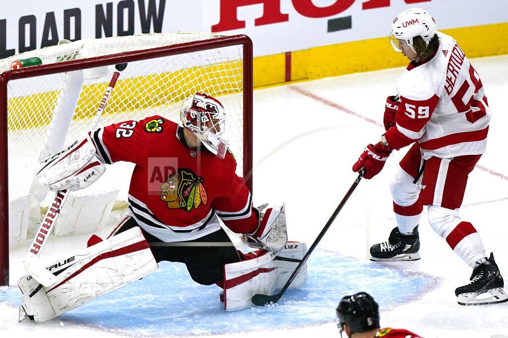 Nam Y. Huh Detroit Red Wings left wing Tyler Bertuzzi, right, scores against Chicago Blackhawks goalie Kevin Lankinen, left, during the second period of an NHL hockey game in Chicago, Sunday, Jan. 24, 2021. (AP Photo/Nam Y. Huh)