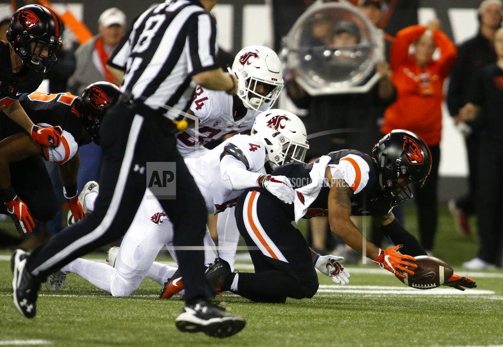 Timothy J. Gonzalez Oregon State's Trevon Bradford, right, grabs a fumble in front of Washington State's Jalen Thompson (34) and Marcus Strong (4) during the first half of an NCAA college football in Corvallis, Ore., Saturday, Oct. 6, 2018. (AP Photo/Timothy J. Gonzalez)