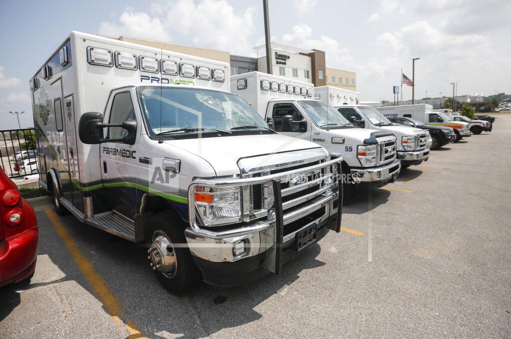 Andrew Jansen Ambulance crews unload equipment at the DoubleTree Hotel on Friday, July 23, 2021, in Springfield, Mo. The crews are part of a medical team that was sent to Springfield to help transport COVID-19 patients in the area. (Andrew Jansen/The Springfield News-Leader via AP)