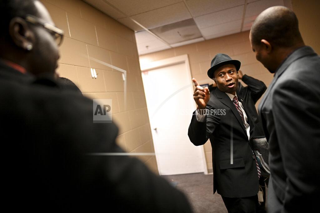 Aaron Lavinsky Erik Anderson, left, of Trenton, N.J., is greeted by Brooklyn Center Mayor-elect Mike Elliott, center, before Elliot's inauguration ceremony, Wednesday, Jan. 2, 2019, at the Brooklyn Center Community Center, in Brooklyn Center, Minn. Elliott is the city's first Black and first Liberian American mayor. Elliott, who emigrated from Liberia as a child, is finding just how difficult it is to turn the page on the nation’s racial history as he handles the fallout from a police shooting. (Aaron Lavinsky/Star Tribune via AP)