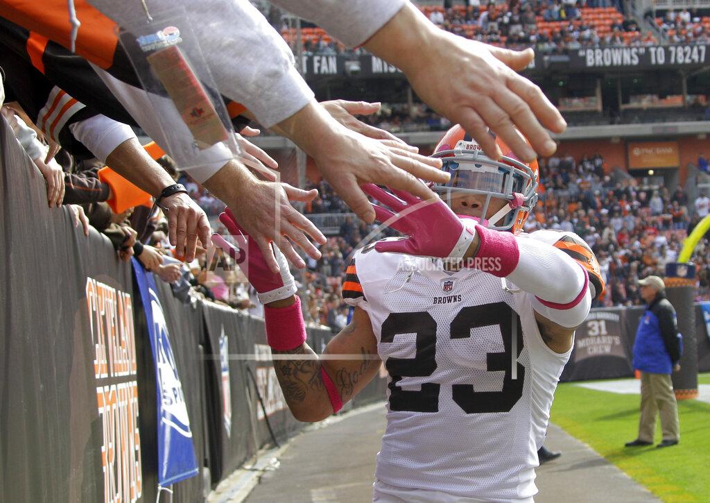 Mark Duncan FILE - In this Oct. 23, 2011, file photo, Cleveland Browns' cornerback Joe Haden greets fans in the Dawg Pound before an NFL football game against the Seattle Seahawks, in Cleveland. As lock-downs are lifted, restrictions on social gatherings eased and life begins to resemble some sense, sports are finally starting to emerge from the coronavirus pandemic. When stadiums do reopen for fans, how are teams going to drive them through the gate?(AP Photo/Mark Duncan, File)