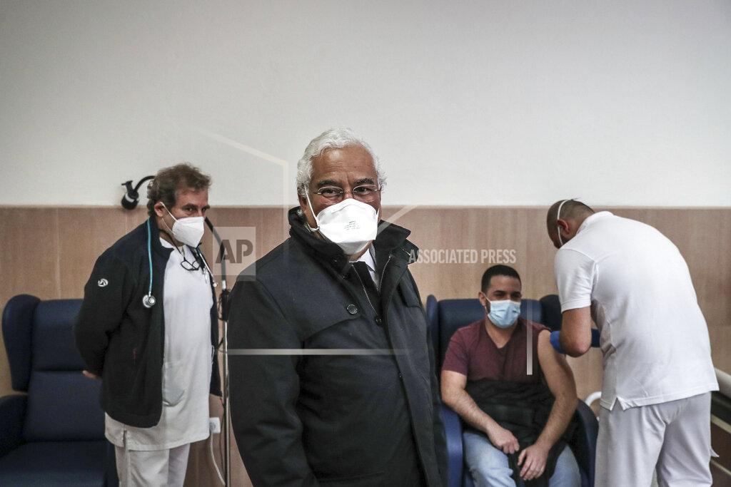Mario Cruz Portuguese Prime Minister Antonio Costa attends the vaccination against COVID-19 of prison workers at the Sao Joao de Deus prison hospital in Oeiras, outside Lisbon, Thursday, Feb. 4, 2021. The new head of Portugal's COVID-19 vaccination task force was due to start work Thursday, a day after his predecessor resigned amid scandals over vaccine queue-jumping and frustration over a sluggish rollout similar to that seen in other European Union countries. (Mario Cruz/Pool via AP)