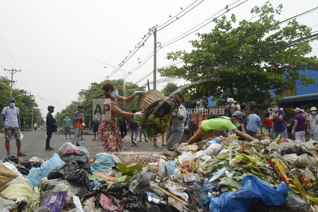 Uncredited Anti-coup protesters throw garbage to block a road as a form of a "silent protest" in Yangon, Myanmar on Tuesday, March 30, 2021. At least 510 protesters have been killed since the coup, as of Tuesday, according to Myanmar's Assistance Association for Political Prisoners, which says the actual toll is likely much higher. (AP Photo)