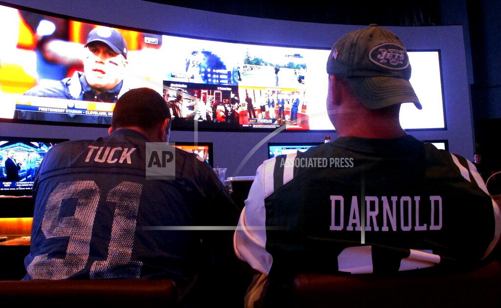 Wayne Parry FILE - This Sept. 9, 2018 file photo shows fans of the New York Giants and Jets watching a football game after placing bets in the sports betting lounge at the Ocean Casino Resort in Atlantic City, N.J. The American Gaming Association estimates more than 31 million people will bet on Sunday's Super Bowl. (AP Photo/Wayne Parry, FILE)