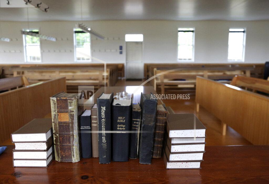 Jessie Wardarski A group of Bibles and religious texts line a small table in the empty church building of the Old Order Stauffer Mennonite Church on Sunday, May 17, 2020, in New Holland, Pa. (AP Photo/Jessie Wardarski)