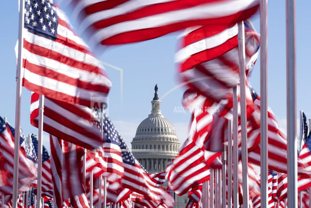 Alex Brandon The U.S. Capitol is seen between flags placed on the National Mall ahead of the inauguration of President-elect Joe Biden and Vice President-elect Kamala Harris, Monday, Jan. 18, 2021, in Washington. (AP Photo/Alex Brandon)