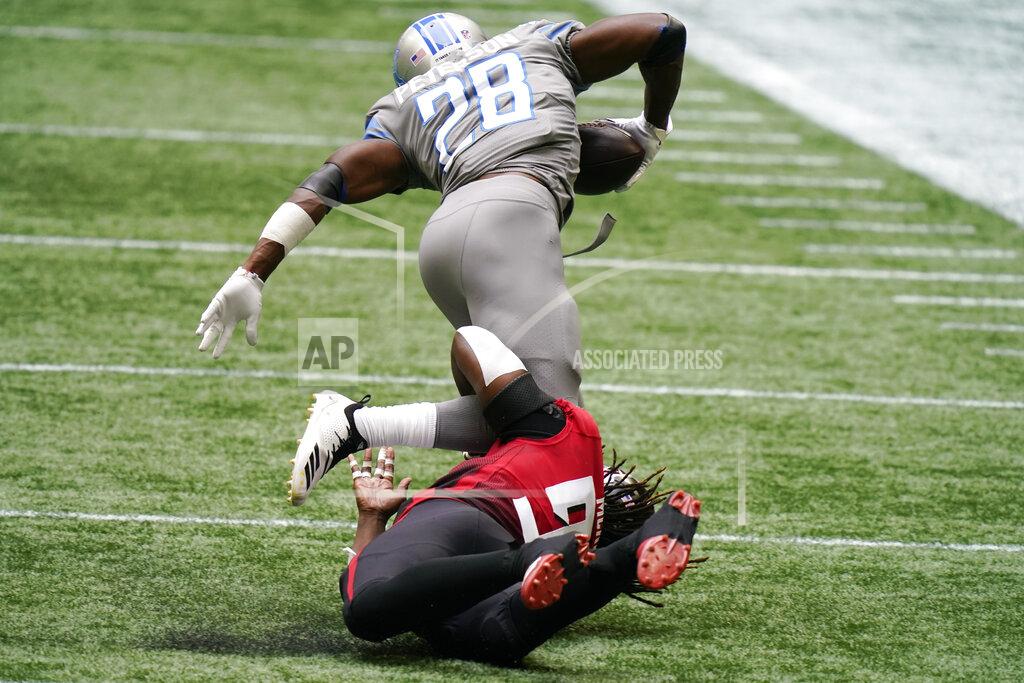 Brynn Anderson Atlanta Falcons defensive end Takkarist McKinley (98) trips up Detroit Lions running back Adrian Peterson (28) during the first half of an NFL football game, Sunday, Oct. 25, 2020, in Atlanta. (AP Photo/Brynn Anderson)