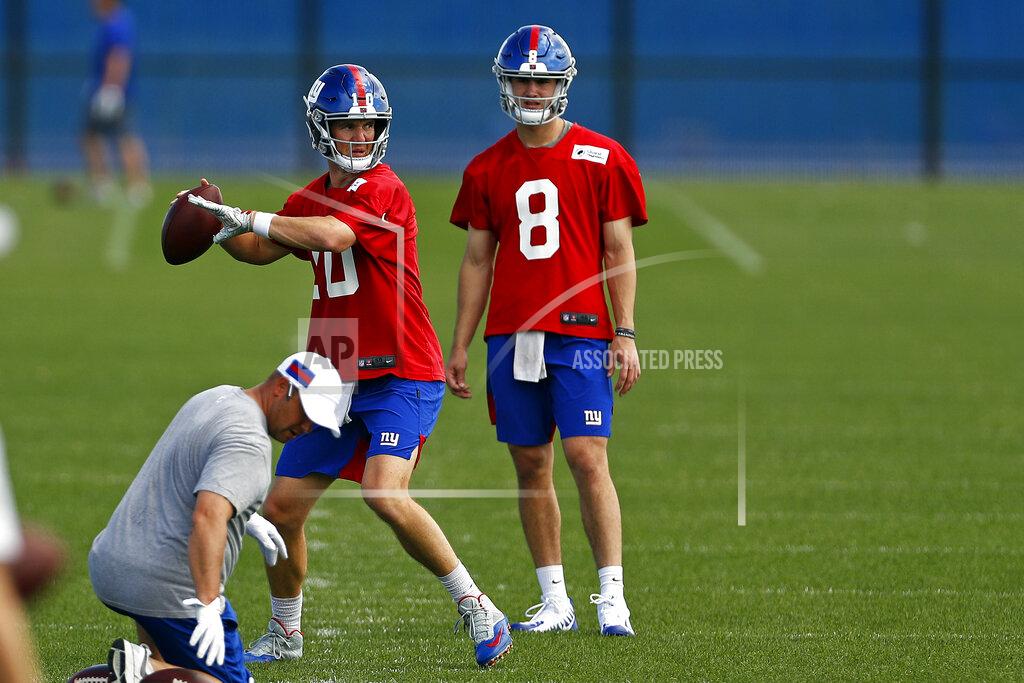Adam Hunger New York Giants quarterback Eli Manning passes in front of quarterback Daniel Jones during an NFL football practice Monday, May 20, 2019, in East Rutherford, N.J. (AP Photo/Adam Hunger)