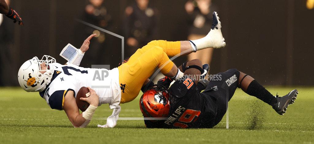 Brody Schmidt Oklahoma State linebacker Justin Phillips (19) sacks West Virginia quarterback Will Grier (7) during the first half of an NCAA college football game in Stillwater, Okla., Saturday, Nov. 17, 2018. (AP Photo/Brody Schmidt)