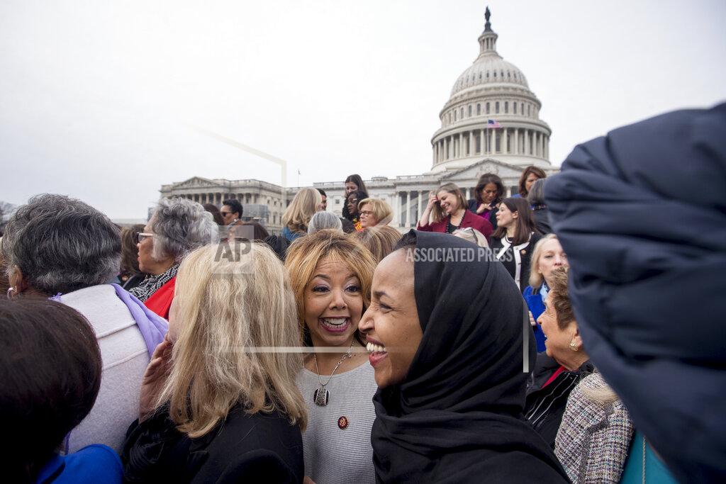 Andrew Harnik FILE - In this Friday, Jan. 4, 2019 file photo, Rep. Lucy McBath, D-Ga., center, smiles with Rep. Ilhan Omar, D-Minn., second from right, following a group portrait of the House Democratic women members of the 116th Congress on the East Front Capitol Plaza Capitol Hill in Washington as the 116th Congress begins. McBath, a Black mother whose 17-year-old son was killed by a white man for playing loud music, won the congressional seat that conservative Newt Gingrich once held. (AP Photo/Andrew Harnik)