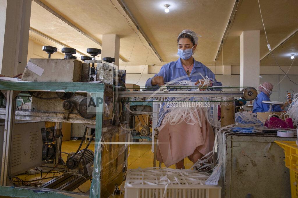 Nariman El-Mofty A woman working at Medic Egypt for Medical Clothes company makes protective face masks to be used to help curb the spread of the coronavirus at a factory in Menoufiya, Egypt, Saturday, June 6, 2020. Egypt has officially ordered its people to wear face masks in public and private transportation, inside government business and offices as it is easing the partial lockdown imposed. Prime Minister Mustafa Madbouly has said violators would be fined as the country has seen a jump of daily reported infections in the past week. (AP Photo/Nariman El-Mofty)