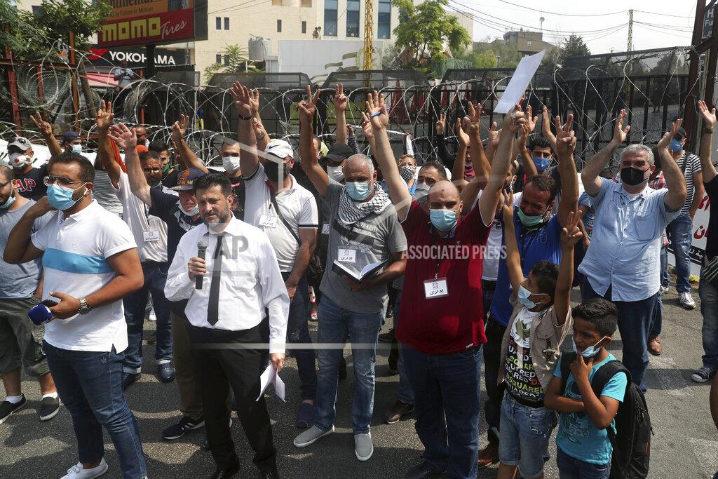 Bilal Hussein FILE - This Wednesday, July 29, 2020 file photo, dozens of Palestinians flash the victory sign as they protest against their permanent settlement in Lebanon and demanding immigration, near the U.S. embassy in Aukar, northeast of Beirut, Lebanon. The financial crisis that the U.N. agency for Palestinian refugees is experiencing could lead to ceasing some of its activities in what would raise risks of instability in this volatile region, the head of the agency said Wednesday, Sept. 16. (AP Photo/Bilal Hussein, File)