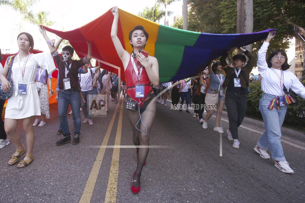 Chiang Ying-Ying Participants march through a street during a pride parade in Taipei, Taiwan, Saturday, Oct. 31, 2020. (AP Photo/Chiang Ying-ying)
