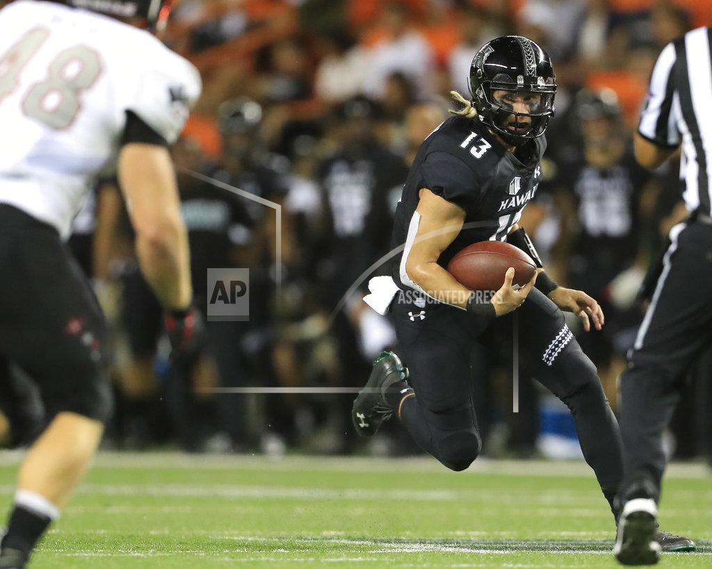 Marco Garcia Hawaii quarterback Cole McDonald (13) scrambles through the UNLV defense trying to gain yards during the second quarter of an NCAA college football game, Saturday, Nov. 17, 2018, in Honolulu. (AP Photo/Marco Garcia)