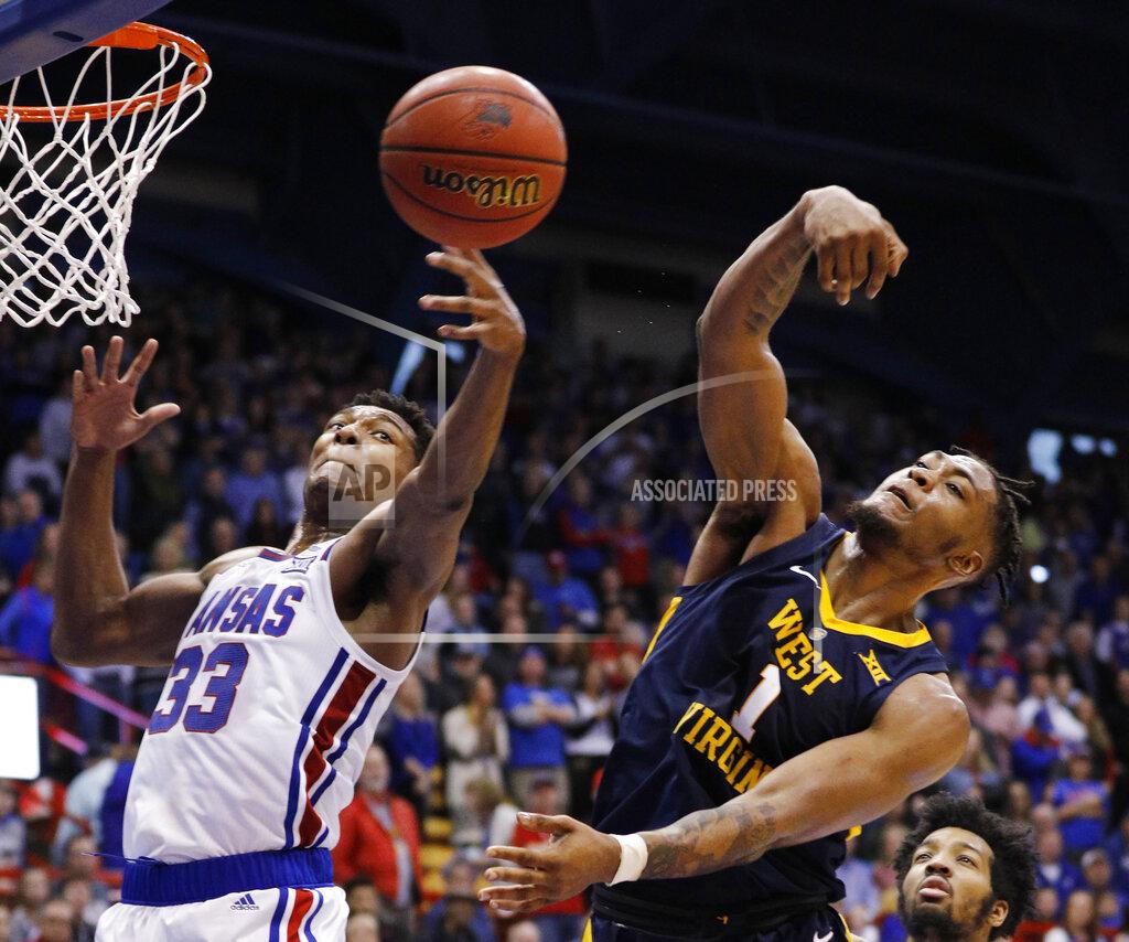 Colin E. Braley Kansas forward David McCormack (33) and West Virginia forward Derek Culver (1) go up for a rebound during the second half of an NCAA college basketball game Saturday, Feb. 16, 2019, in Lawrence, Kan. (AP Photo/Colin E. Braley)