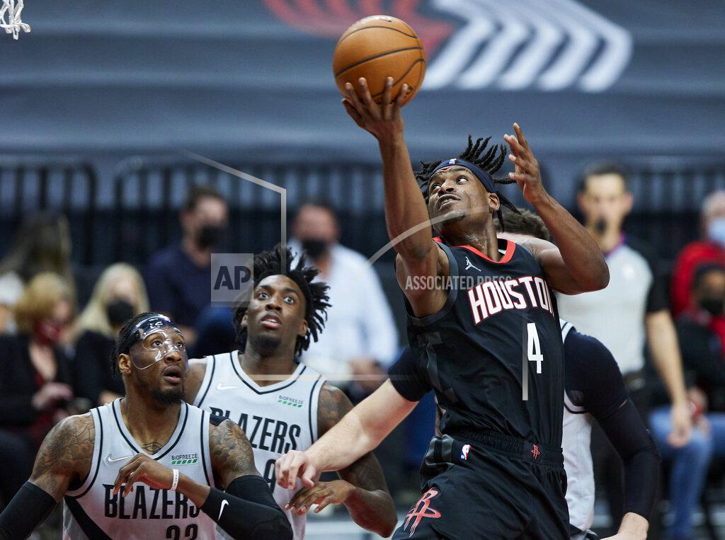 Craig Mitchelldyer Houston Rockets forward Danuel House Jr., right, shoots over Portland Trail Blazers forwards Robert Covington, left, and Nassir Little during the first half of an NBA basketball game in Portland, Ore., Monday, May 10, 2021. (AP Photo/Craig Mitchelldyer)