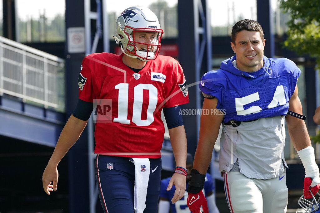 Steven Senne New England Patriots quarterback Mac Jones (10) and New York Giants inside linebacker Blake Martinez (54) step on the field at the start of a joint NFL football practice, Wednesday, Aug. 25, 2021, in Foxborough, Mass. (AP Photo/Steven Senne)