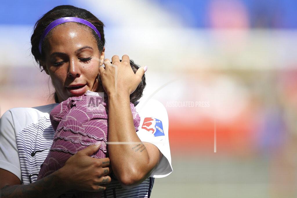 Steve Luciano FILE - In this Sunday, Sept. 29, 2019 file photo, Orlando Pride forward Sydney Leroux (2) holds her child on the pitch after an NWSL soccer match against Sky Blue FC in Harrison, N.J. Sydney Leroux simply isn't done chasing her soccer dreams. The veteran forward signed a 3-year max deal with the Orlando Pride, the National Women's Soccer League team she's been with since 2018. Announced Wednesday, Feb. 3, 2021 the contract has an option for an additional year. (AP Photo/Steve Luciano, File)