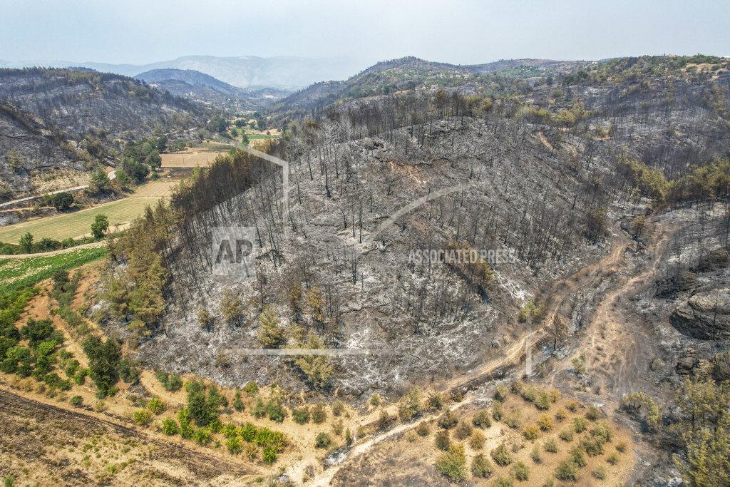 Uncredited An aerial photo shows destruction by wildfires near the Mediterranean coastal town of Manavgat, Antalya, Turkey, Friday, July 30, 2021. The death toll in a string of wildfires raging in southern Turkey rose to four, officials said Friday, as fire crews continued to battle blazes that burned down homes and forced people to evacuate settlements and beach resorts. Firefighters were still tackling wildfires in 14 locations in six provinces in Turkey's Mediterranean and southern Aegean region, President Recep Tayyip Erdogan told reporters. (AP Photo)