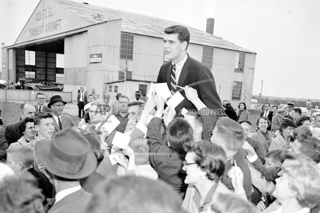 Rudolph Faircloth FILE - In this March 24, 1957, file photo, North Carolina college basketball player Joe Quigg is carried by fans in Raleigh, N.C., after returning from the Final Four in Kansas City, where UNC beat Kansas 54-53 in the championship game. (AP Photo/Rudolph Faircloth, File)