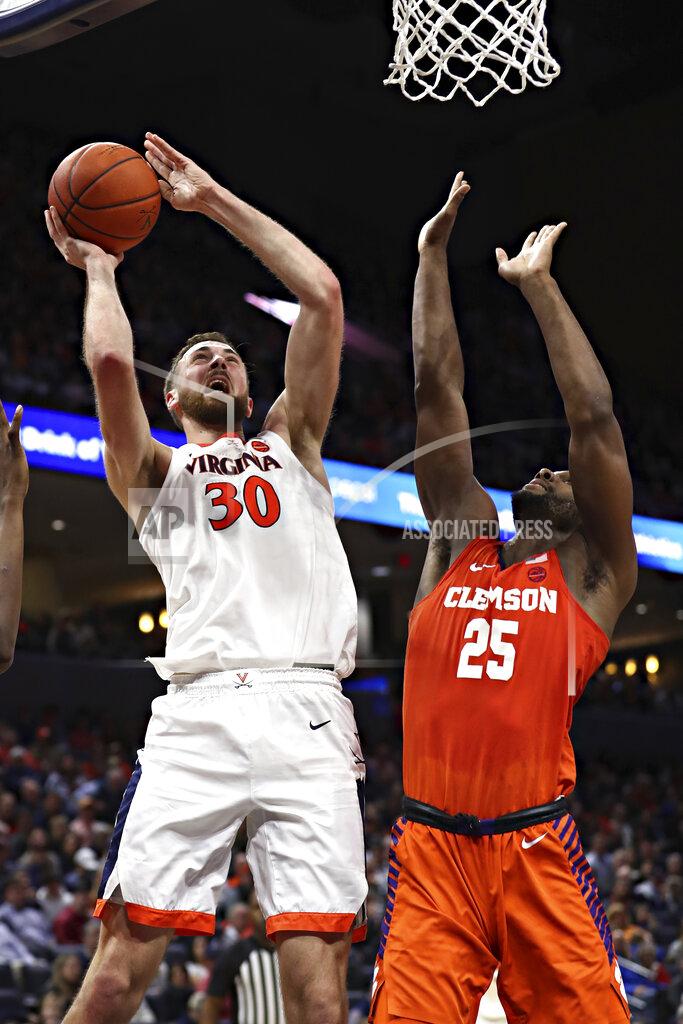 Erin Edgerton Virginia forward Jay Huff (30) shoots next to Clemson's Aamir Simms during an NCAA college basketball game Wednesday, Feb. 5, 2020, in Charlottesville, Va. (Erin Edgerton/The Daily Progress via AP)