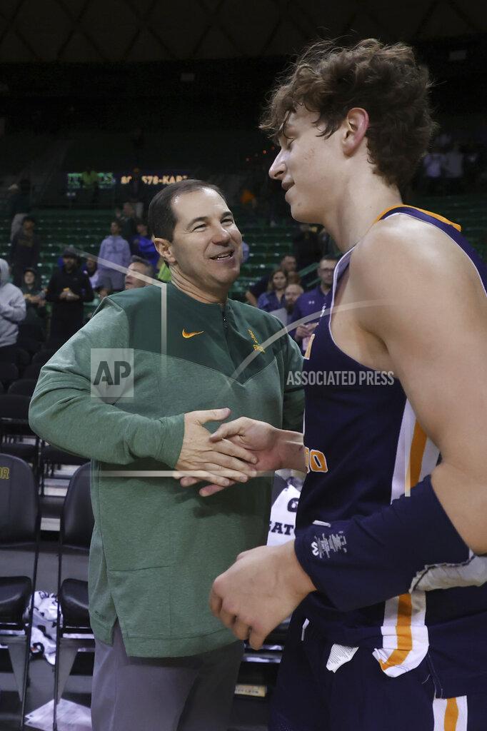 Rod Aydelotte Baylor head coach Scott Drew, left, shakes hands with his nephew Northern Colorado guard Caleb Shaw (30) following an NCAA college basketball game, Monday, Nov. 14, 2022, in Waco, Texas. (AP Photo/Rod Aydelotte)