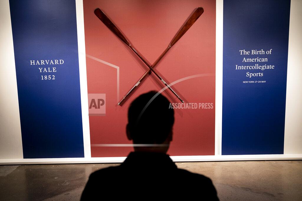 John Minchillo The Harvard-Yale Regatta 1852 Trophy Oars are displayed before an auction, Thursday, April 21, 2022, at Sotheby's in the Manhattan borough of New York. Sotheby's estimates the oars value between three and five million dollars. The oars were awarded to Harvard's winning crew and represent one of the oldest collegiate athletic competitions in the nation's history. (AP Photo/John Minchillo)