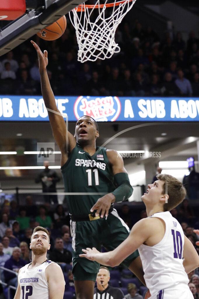 Nam Y. Huh Michigan State forward Aaron Henry, center, shoots between Northwestern guard Pat Spencer, left, and forward Miller Kopp during the first half of an NCAA college basketball game Wednesday, Dec. 18, 2019, in Evanston, Ill. (AP Photo/Nam Y. Huh)