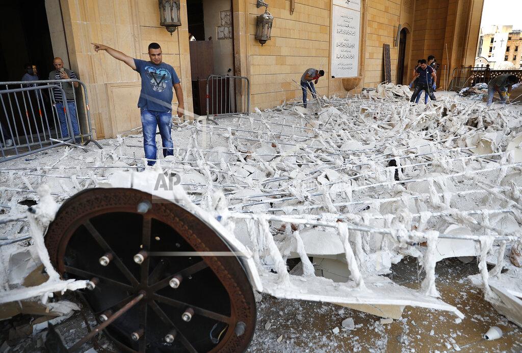 Hussein Malla People remove debris from a damaged mosque a day after an explosion hit the seaport of Beirut, Lebanon, Wednesday, Aug. 5, 2020. Residents of Beirut confronted a scene of utter devastation on Wednesday, a day after a massive explosion at the port rippled across the Lebanese capital, killing at least 100 people, wounding thousands and leaving entire city blocks flooded with glass and rubble. (AP Photo/Hussein Malla)
