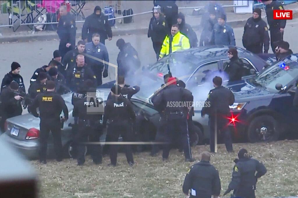 Uncredited In this image take from video, law enforcement personnel surround a car after it was stopped as the driver approached the crowd near Union Station attending the Super Bowl parade and rally for the Kansas City Chief in Kansas City, Mo., Wednesday, Feb. 5, 2020. (FOXKC via AP)