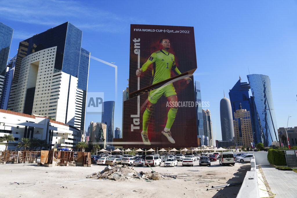 Pavel Golovkin A construction cite is seen in front of a building with a Germany's goalkeeper Manuel Neuer's portrait in Lusail downtown, Qatar, Thursday, Nov. 24, 2022. (AP Photo/Pavel Golovkin)